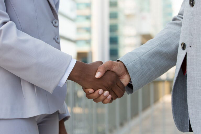 multiethnic leaders greeting each other city
